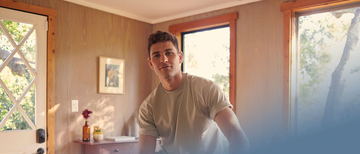 Man sitting and smiling contently